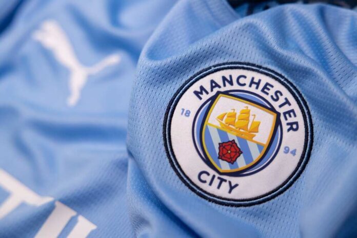 Close-up of a Manchester City football jersey with the team logo