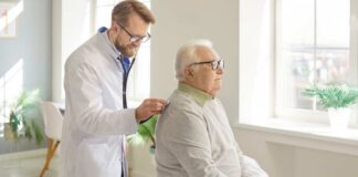 Doctor examining an elderly patient in a bright medical office