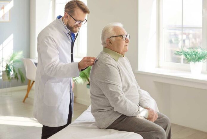 Doctor examining an elderly patient in a bright medical office