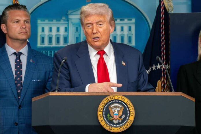 A man in a suit speaking at a podium during a press conference