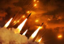 Multiple rockets launching into a fiery sky