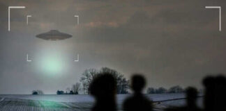 UFO hovering over field with people observing