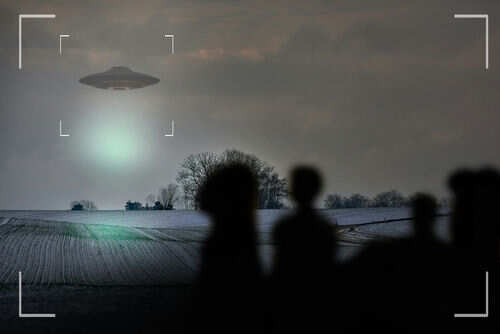 UFO hovering over field with people observing
