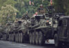 Armored military vehicles in a street parade