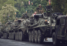 Armored military vehicles in a street parade