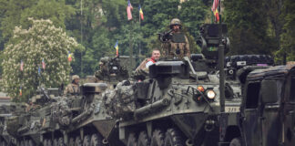 Armored military vehicles in a street parade