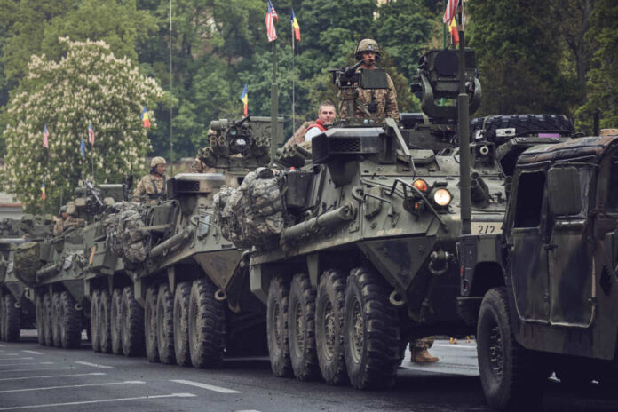 Armored military vehicles in a street parade