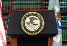 U.S. Department of Justice podium with seal.
