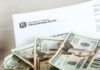 IRS letter with scattered U.S. dollar bills.