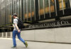 Man walking past JPMorgan Chase & Co. building facade