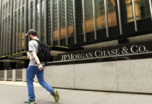Man walking past JPMorgan Chase & Co. building facade