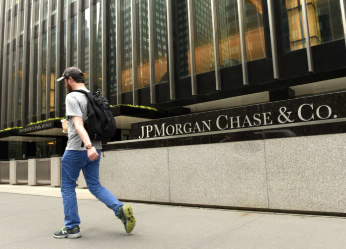 Man walking past JPMorgan Chase & Co. building facade