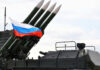 Military launcher with four missiles and Russian flag