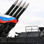 Military launcher with four missiles and Russian flag