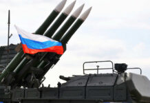 Military launcher with four missiles and Russian flag