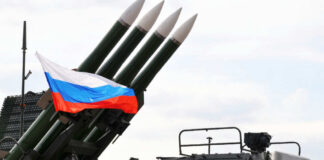 Military launcher with four missiles and Russian flag