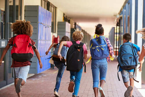 school735954742jpg Children with backpacks running in a school corridor