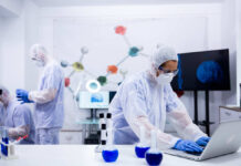 Scientists in a lab conducting research with equipment and a computer