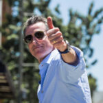 Newsom vs. Fox: Malice Ruling Spells Trouble Man giving a thumbs up while wearing sunglasses