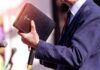 Giants As CEOs? Genesis Hints Explode A person in formal attire holding a Bible while speaking