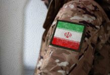 Close-up of a military uniform with an Iranian flag patch