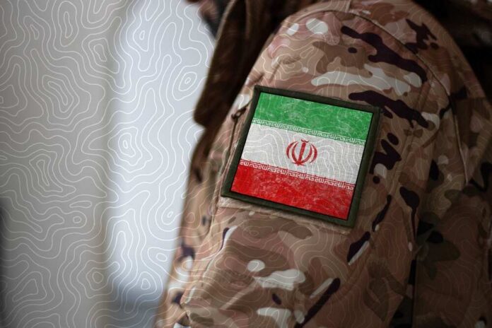 shutterstock_2315840771.jpg Close-up of a military uniform with an Iranian flag patch