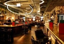 Interior view of a modern bar with decorative lighting and patrons