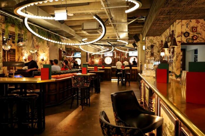 Interior view of a modern bar with decorative lighting and patrons