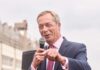 A politician speaking into a microphone at an outdoor event