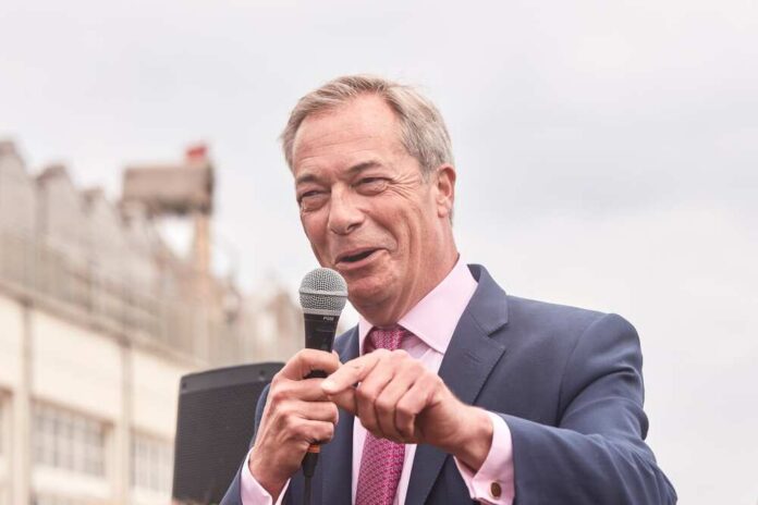 A politician speaking into a microphone at an outdoor event
