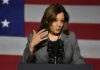 Kamala Harris: American Dream Now a Myth? A female politician speaking at a podium with an American flag backdrop