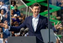 A speaker passionately addressing a crowd at an outdoor event