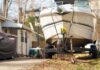 A boat on a trailer parked in a residential area