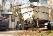 A boat on a trailer parked in a residential area