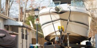 A boat on a trailer parked in a residential area