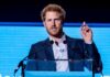 Rising Antisemitism in UK: Harry’s Alarming Message A man in a suit speaking at a podium during a conference
