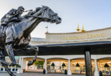 Bronze statue of a horse and jockey in front of Churchill Downs