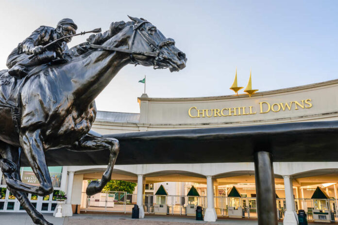 Bronze statue of a horse and jockey in front of Churchill Downs