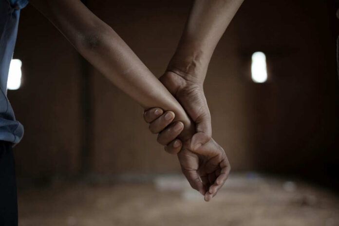 human-rights-violations2184965819jpg Close-up of one hand gripping another person's wrist