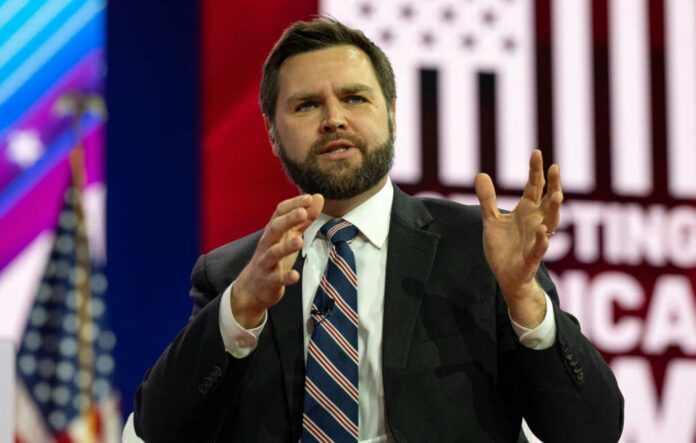 jd-vance2270811629jpg Man in suit speaking on stage with gesturing hands