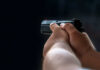 Missing Footage, Dead Dog, Explosive Questions Person holding a black handgun in firing position