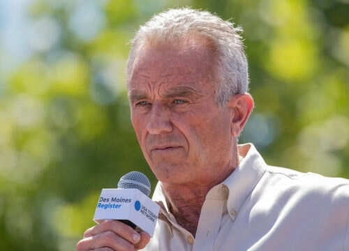 Man speaking into microphone at outdoor event