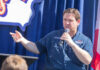 Person speaking into microphone during public event