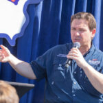 Person speaking into microphone during public event