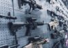 A wall displaying various firearms in a gun shop