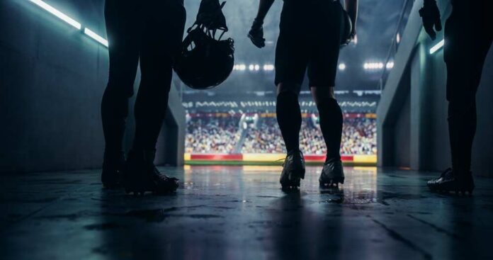 Football players standing in a tunnel before entering the stadium