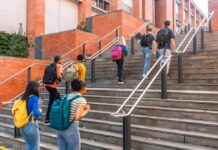 Group of students ascending outdoor stairs on a campus