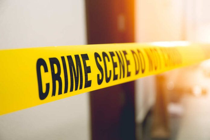 Yellow crime scene tape with the words 'CRIME SCENE DO NOT CROSS'
