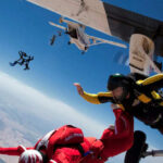 Skydivers jumping from an airplane in midair