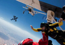 Skydivers jumping from an airplane in midair